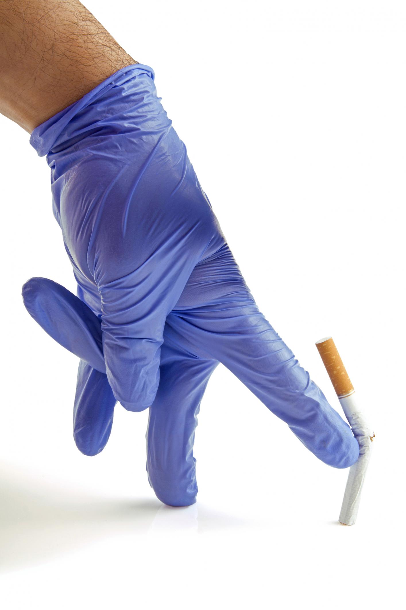 gloved hand throwing cigarette
