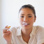 Young woman using e-cigarette: Smokestage Medical Marijuana Blog